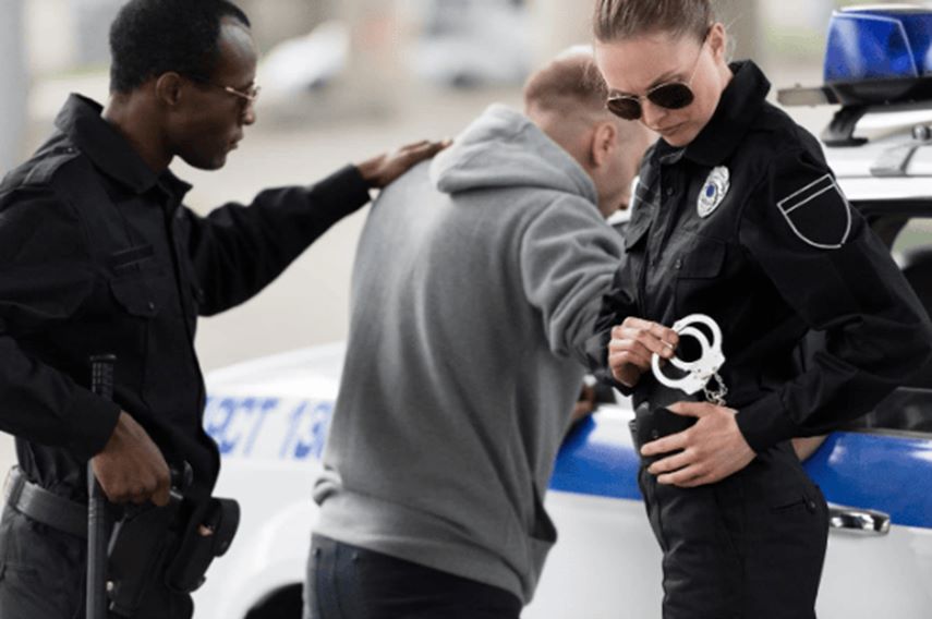 police officer provides assistance to a man getting into a car